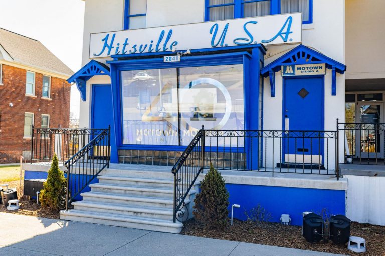 Exterior of the Hitsville U.S.A. building, home of the Motown Museum, featuring blue and white paint, a Motown Studio A sign, and front steps leading to the entrance.